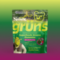 Green Grüns Superfoods Greens Gummies package featuring the Shrek logo and character, labeled Berry Far Far Away flavor, listing support for gut health, energy, immunity, recovery, beauty, and cognition, Dietary Supplement, 28 Daily Packs, on a green-to-purple gradient background.